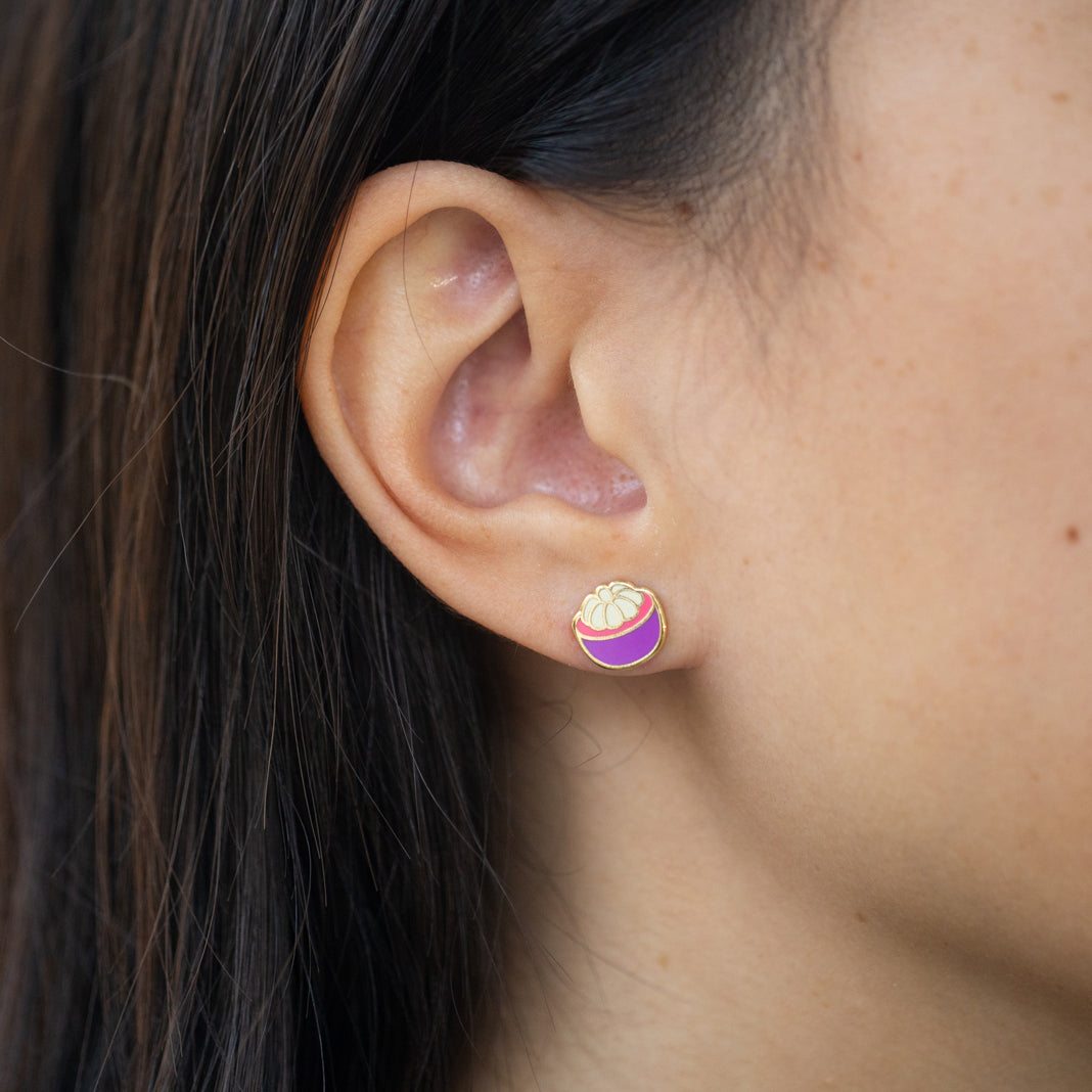 Close-up of person wearing open mangosteen stud earring