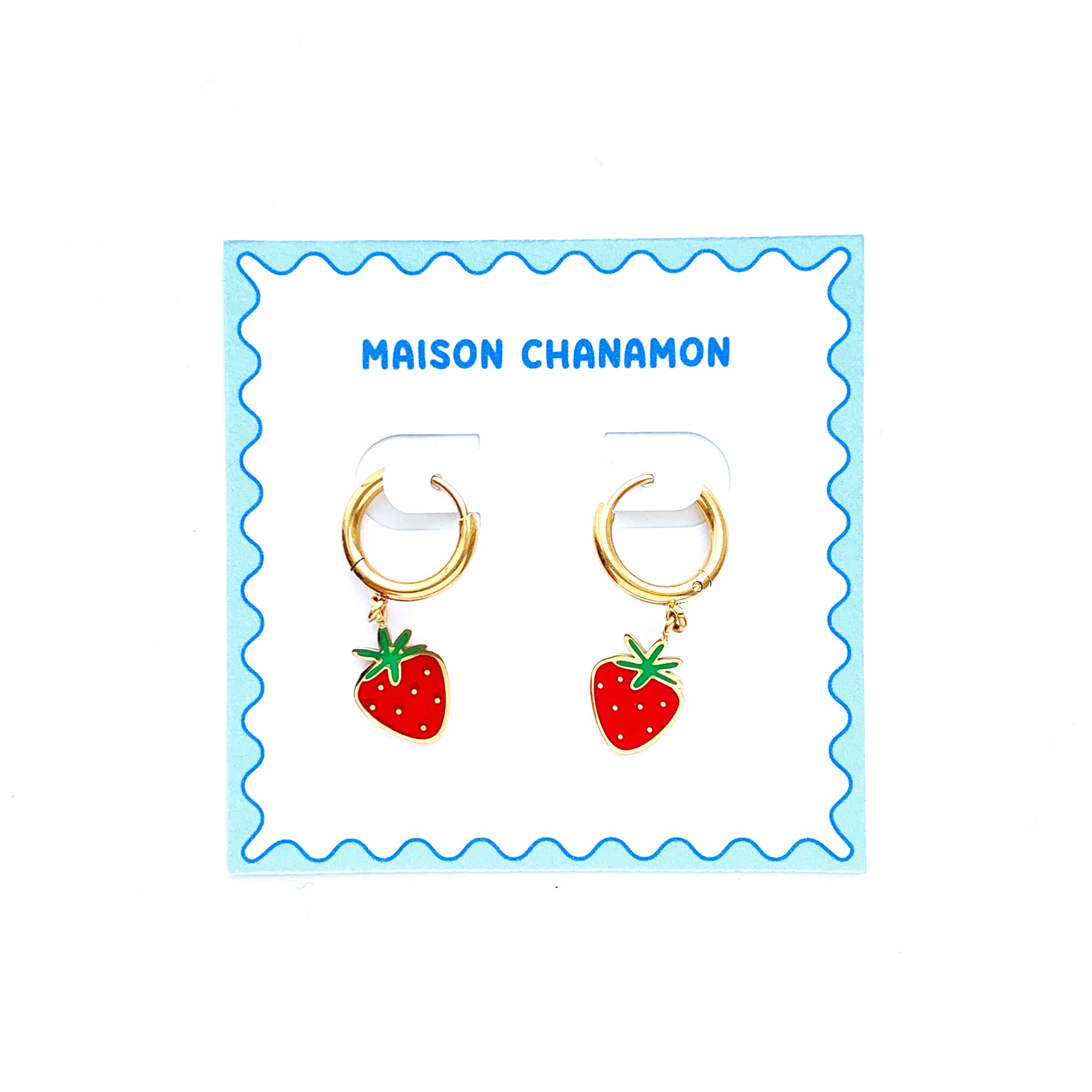 Strawberry enamel charms on gold huggie hoop earrings on a backing card