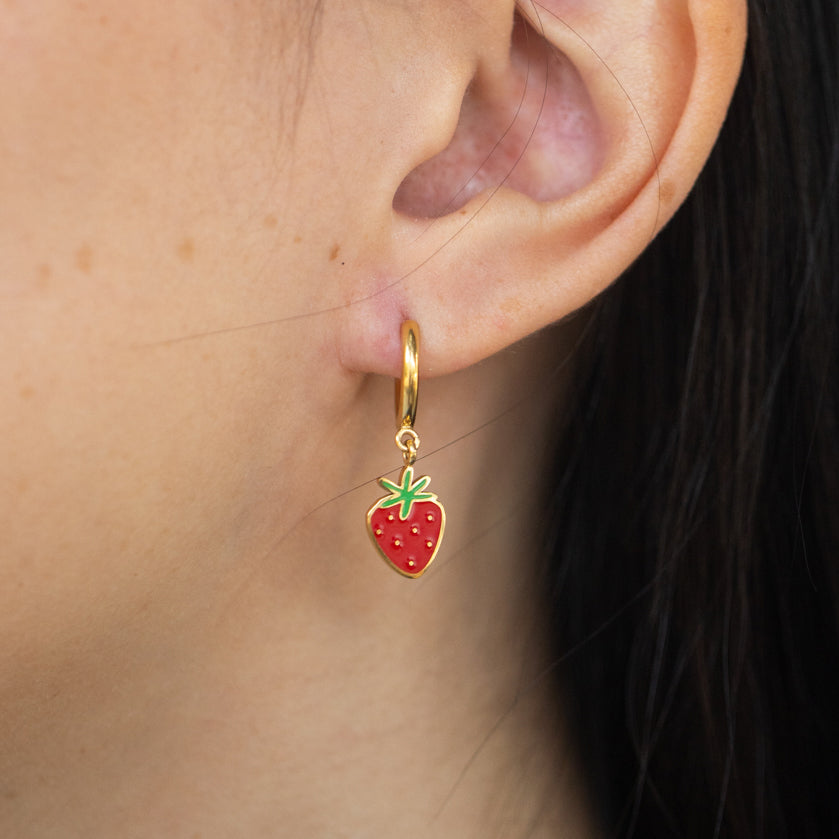 Close-up of person wearing strawberry hoop earring