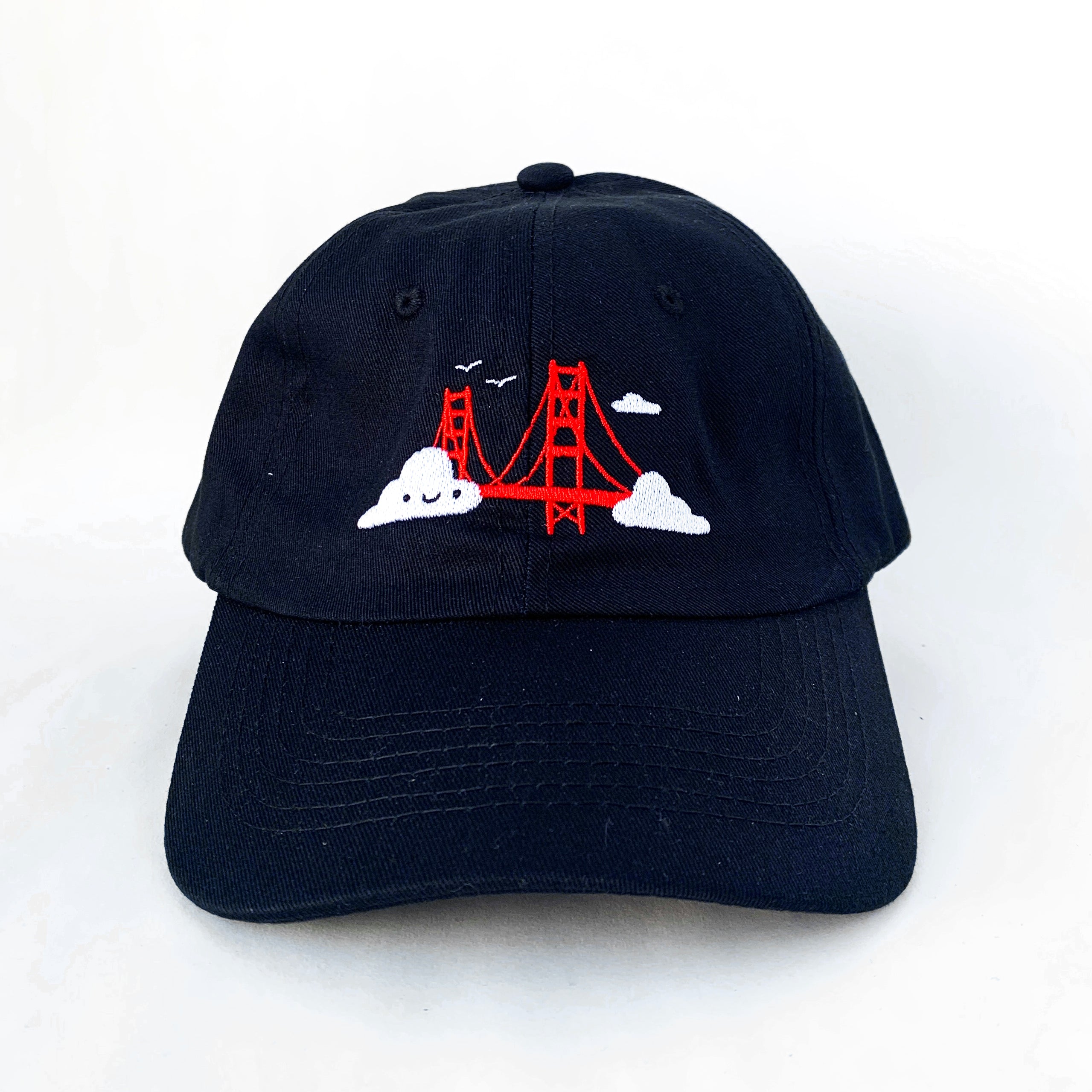 Black baseball cap with Golden Gate Bridge and smiling clouds embroidery.