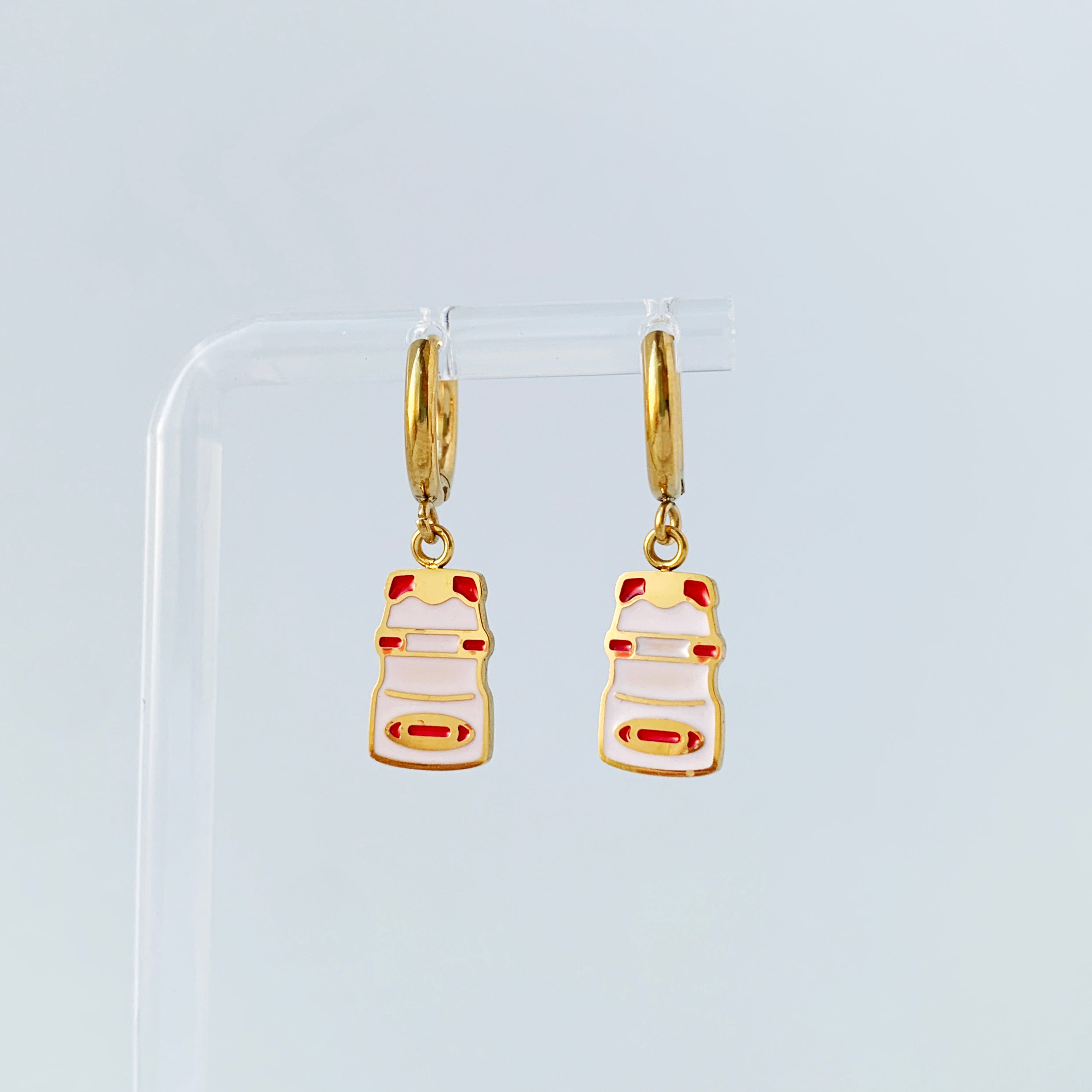 Small gold hoop earrings with charms of a yakult bottles