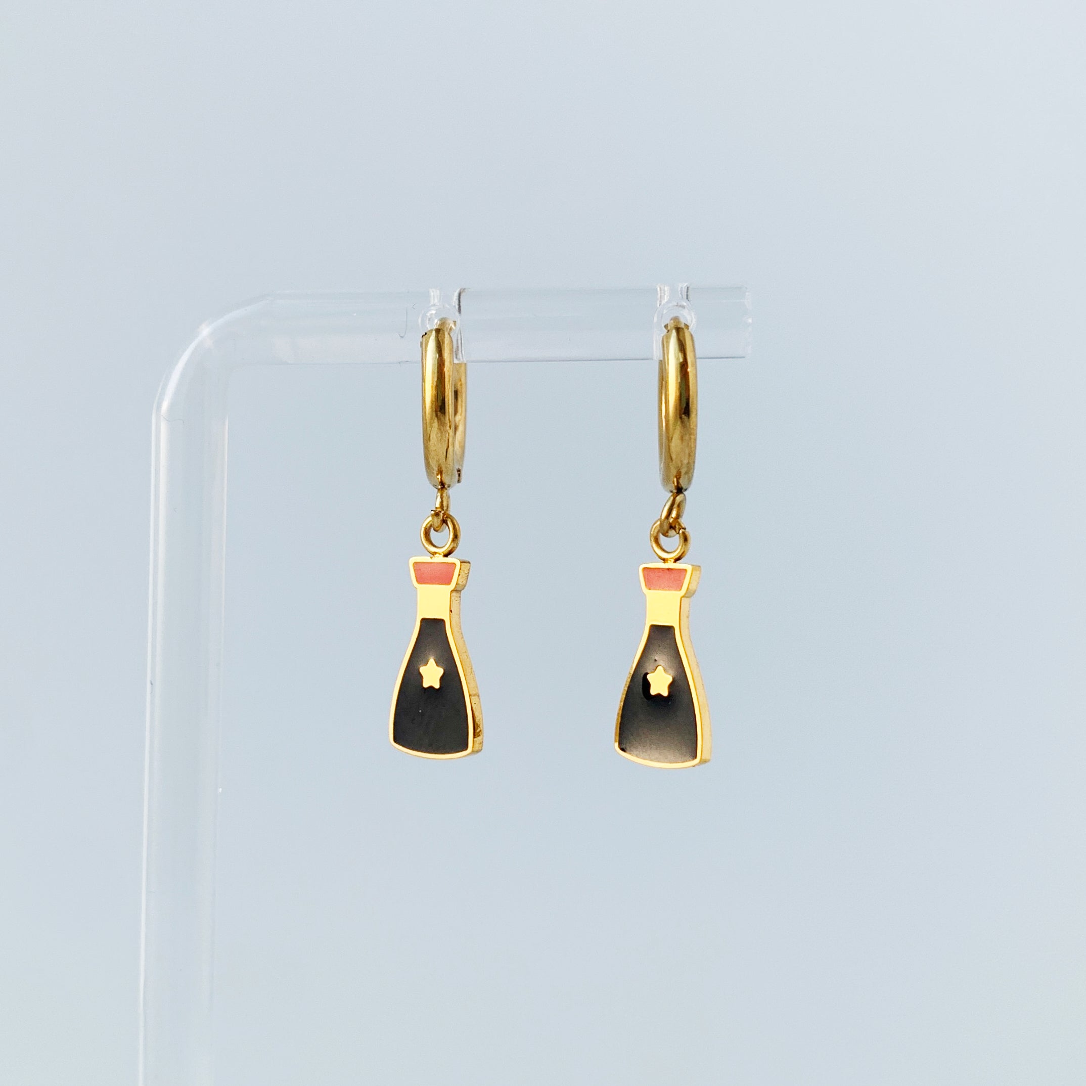 Small gold hoop earrings with charms of a soy sauce bottles 